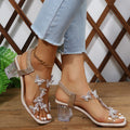 Damen Glamouröse Sandalen mit funkelnden Schmetterlingsdetails und transparentem Blockabsatz Selmira