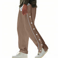 Herren nan weite Trackpants mit seitlicher Druckknopfleiste, elastischem Bund und reflektierendem Streamline-Streifen